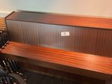 a wooden bench with a metal back and a black chair