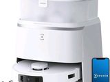 a white machine that is sitting next to a cell phone