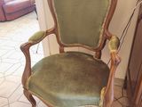 a green chair that is sitting in the corner of a room