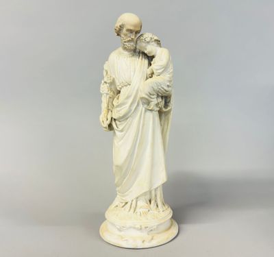 a statue of a man holding a child in his arms