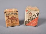 two boxes of camel cigarettes sitting next to each other on a table