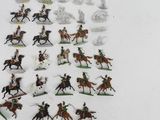 a lot of toy figurines of people riding horses