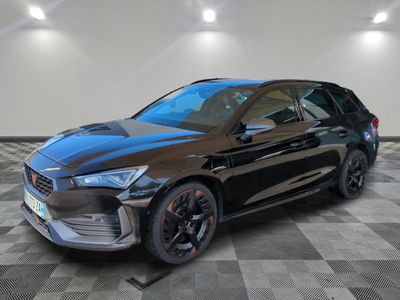 a black car parked in a garage with a checkered floor