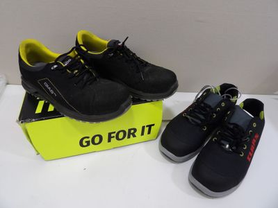 pair of black and yellow shoes sitting on top of a box