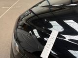 cars parked in a parking lot with a parking ticket attached to the hood of the car