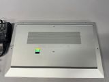 a silver laptop with a green sticker on it
