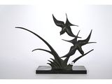 an image of a sculpture of two fish on a stone base