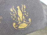 a black hat with a yellow handprint on it
