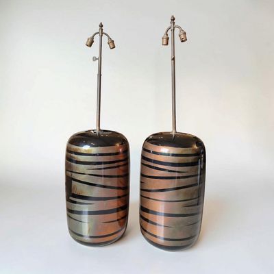 pair of black and copper striped vases on a white background