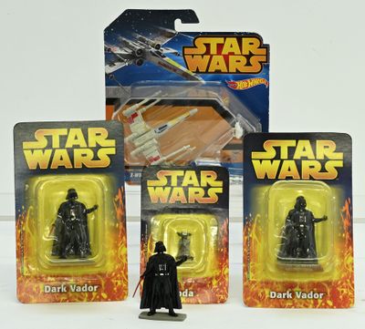 three star wars action figures sit in front of each other