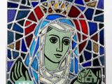 stained glass of the virgin of guadalupe with a crown on her head