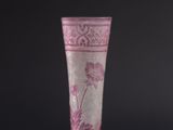 a pink vase with a floral design on it