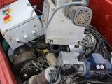 a red box filled with assorted electronics on the ground