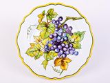 a plate with a bunch of grapes painted on it