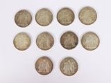 a close up of a bunch of coins sitting on top of a white surface