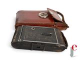 an old camera with a leather case on it