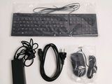 an image of a computer keyboard and mouse with a charger