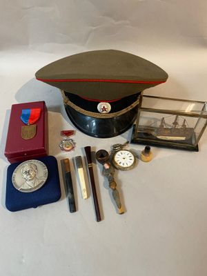 a hat, watch, keys, and other items on a table