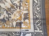 a table cloth with a design on it on a wooden floor