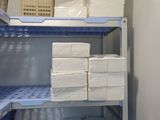 a shelf that has many boxes on top of it