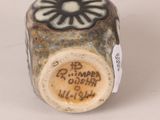 a small vase with a label on it that says b d timper queen of wales