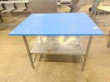 a blue table that is sitting in the middle of a room