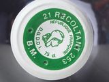 a close up of a plastic cup with a green lid