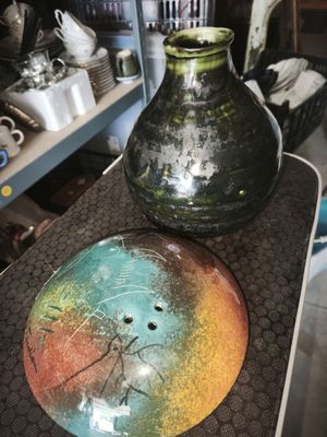 two vases sitting on top of a table in a room
