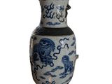 a blue and white vase sitting on a white surface