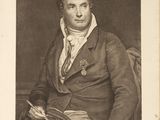 portrait of a man in a suit and tie sitting in a chair