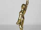 an image of a gold statue of a man holding a basketball ball