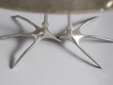 two forks sticking out of a silver bowl on a table