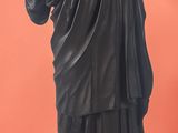 a statue of a man holding a bottle of wine
