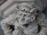 a small statue of a man with a hat on his head