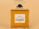 a bottle of chanel parfum perfume on a beige background