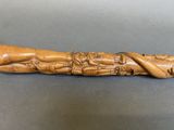 an old wooden carving of a person laying down on the ground