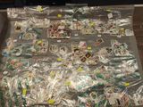many bags of candy sitting on a table in a room