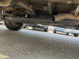 a close up of a car under a vehicle on the street