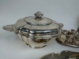 a silver plate with a lid and a spoon on it