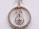 an image of a silver pendant with a crystal in the center