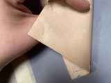 a person that is holding a piece of paper in their hand