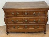 an old wooden chest of drawers with brass hardware on top