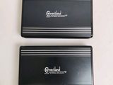 two black and white business cards sitting on top of each other
