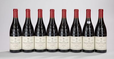 six bottles of wine lined up in a row on a table