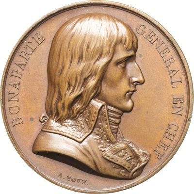 une image représentant une médaille de bronze à l'effigie d'un homme aux cheveux longs