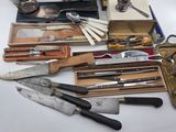 many different types of knives and knives on the table