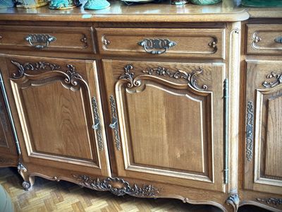 a wooden cabinet with a marble top on a hard wood floor