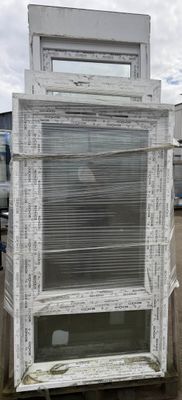 a stack of old windows sitting on top of a pallet