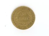 a gold coin on a white surface with a white background