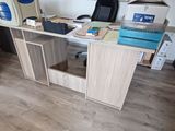 a desk with a computer on it in the corner of a room